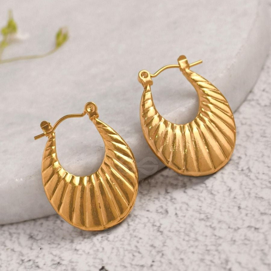  A pair of Croissant Earrings featuring a ridged, textured design inspired by classic Parisian style.