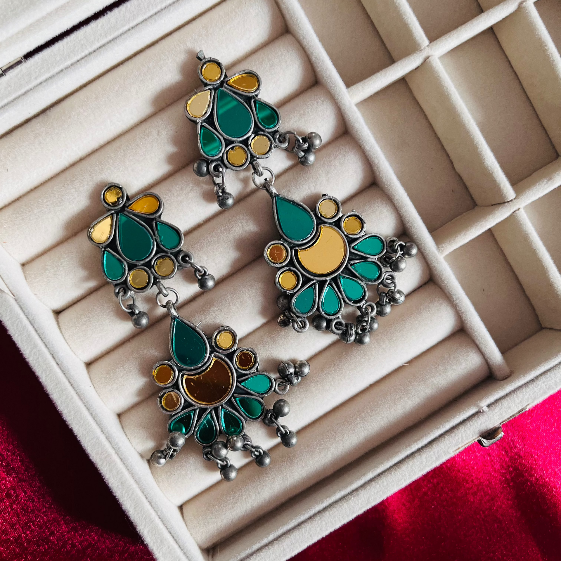 A pair of Green Darpan Earrings featuring oxidized silver craftsmanship with elegant green stone detailing, perfect for a vintage and boho look.