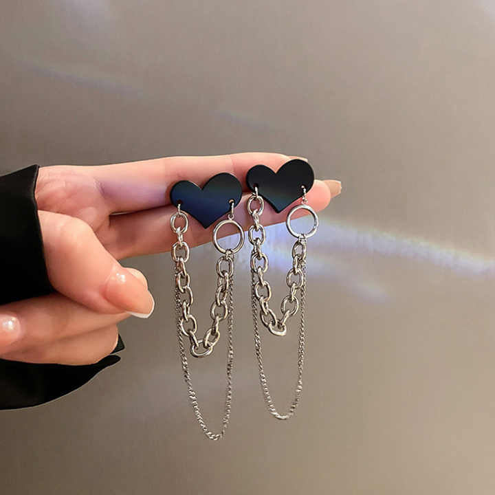 A pair of Heart Chain Earrings featuring delicate heart pendants connected by a sleek chain, inspired by Korean aesthetics.

